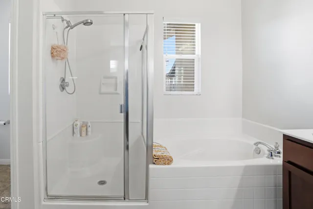 a bathroom with a shower and a bath tub