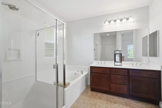 a bathroom with a tub sink and mirror