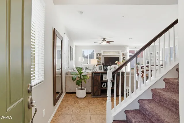 a view of entryway and hall with wooden floor