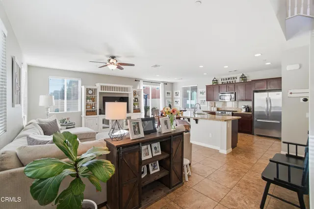 a living room with kitchen island furniture and a view of kitchen