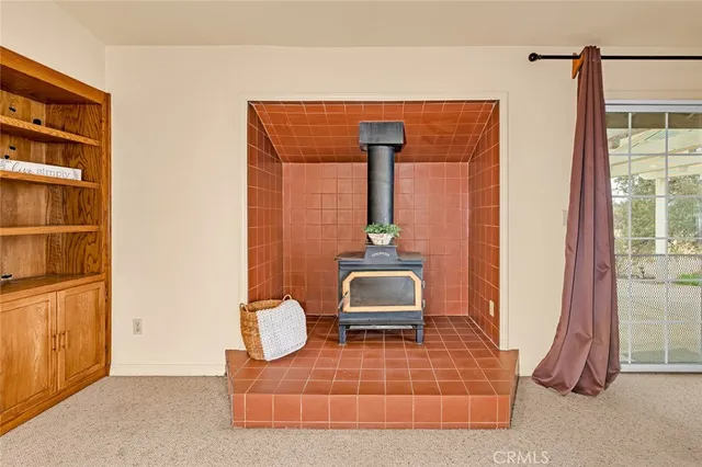 an empty room with closet and a chandelier fan