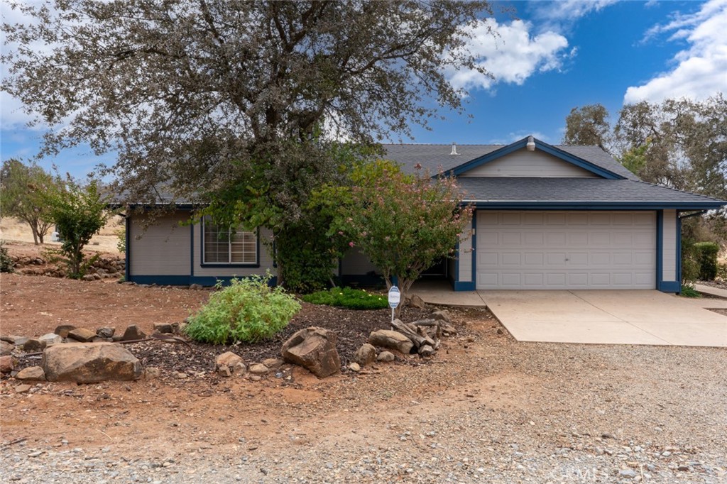 5030 Creek Front Road Catheys Valley, CA 95306 - Photo 2 of 69 a front view of a house with a yard and garage