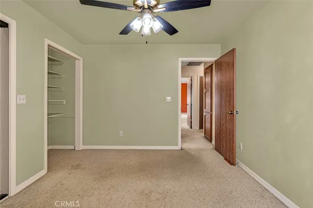 a view of a patio with a table and chairs under an umbrella