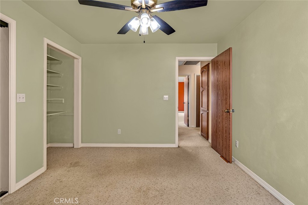5030 Creek Front Road Catheys Valley, CA 95306 - Photo 26 of 69 an empty room with closet and a chandelier fan