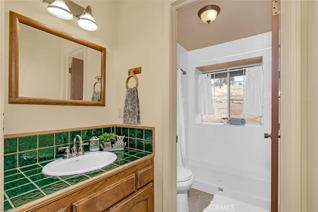a view of a patio with table and chairs and a large tree