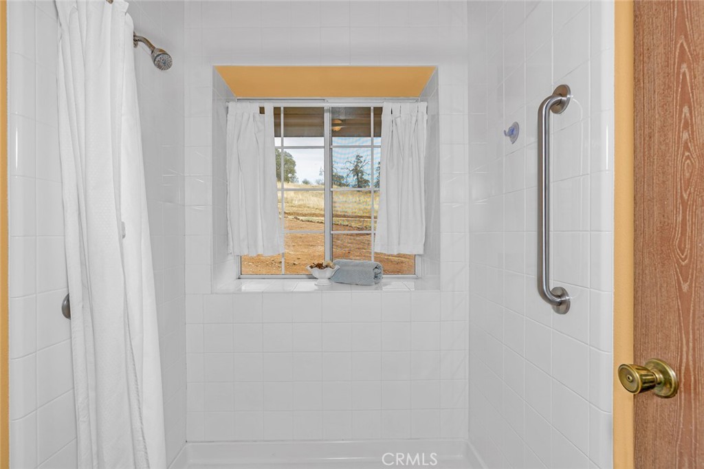 5030 Creek Front Road Catheys Valley, CA 95306 - Photo 30 of 69 a bathroom with a window