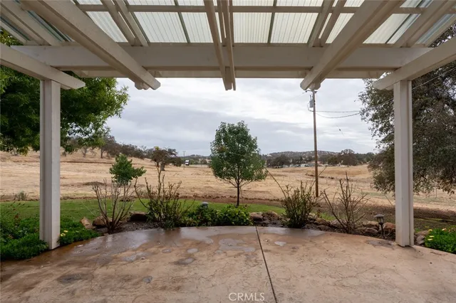 a kitchen with a stove a sink dishwasher and a refrigerator with wooden floor