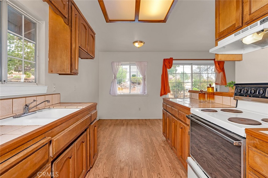 5030 Creek Front Road Catheys Valley, CA 95306 - Photo 48 of 69 a kitchen with stainless steel appliances granite countertop a sink stove and cabinets