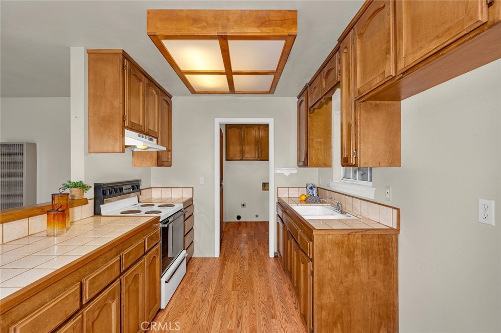 5030 Creek Front Road Catheys Valley, CA 95306 - Photo 51 of 69 a kitchen with stainless steel appliances granite countertop a sink a stove cabinets counter space and a window