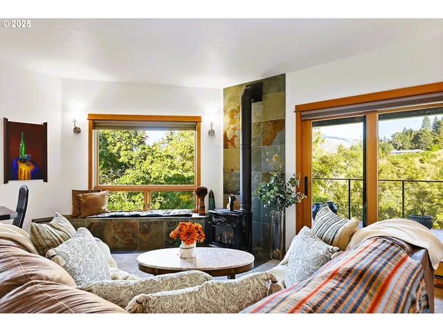 a living room with furniture and large windows