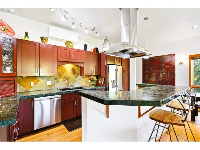 a kitchen with stainless steel appliances granite countertop a stove and a sink