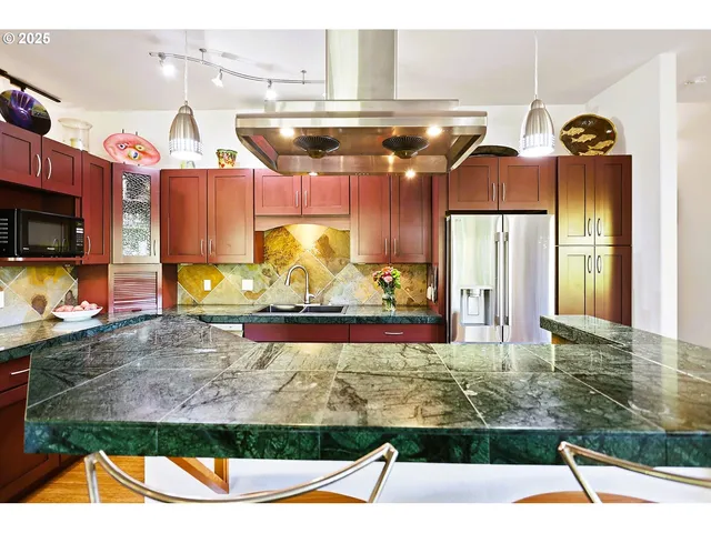 a kitchen with a stove a sink and a refrigerator