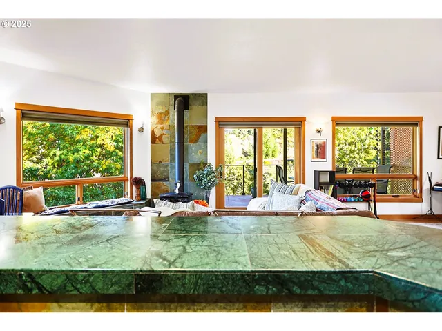 a living room with furniture and a open kitchen view