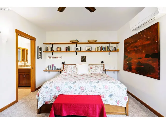 a view of a bedroom with baby bed and a window