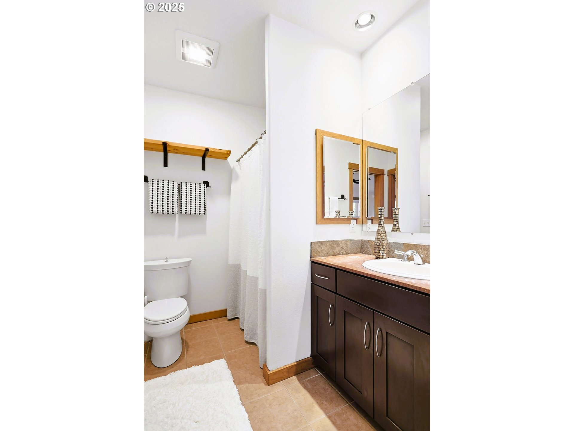 515 East 4th Street, Unit 2 Hood River, OR 97031 - Photo 39 of 48 a bathroom with a toilet sink and mirror