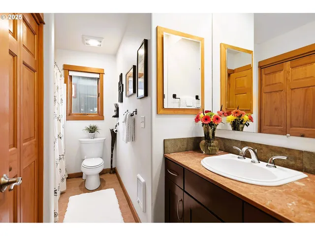 a bathroom with a toilet and a shower curtain