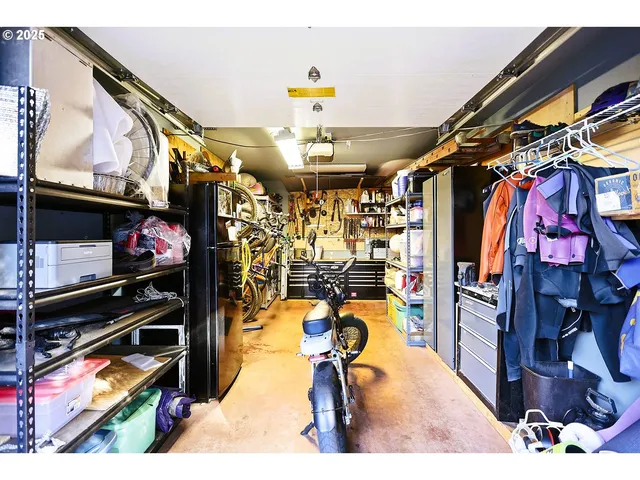 a kitchen with stainless steel appliances kitchen island granite countertop a stove and a living room