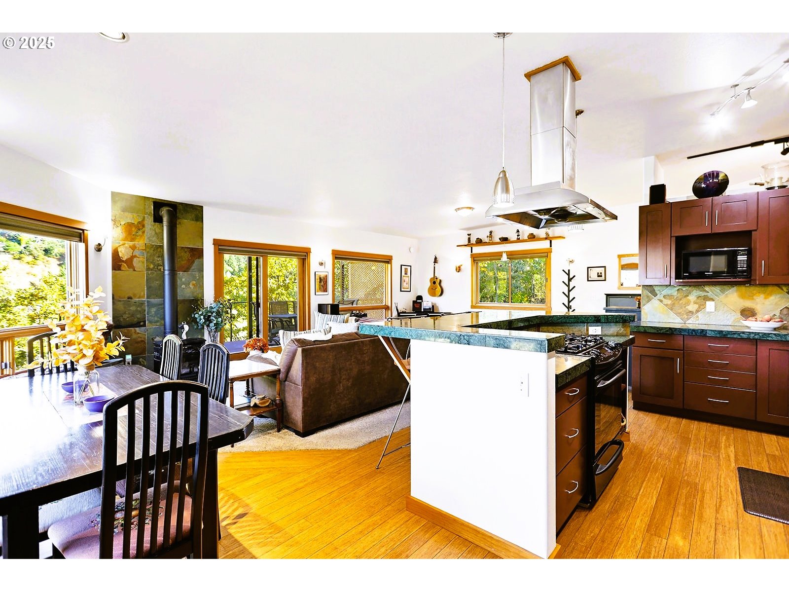 515 East 4th Street, Unit 2 Hood River, OR 97031 - Photo 48 of 48 a kitchen with stainless steel appliances kitchen island granite countertop a stove and a living room