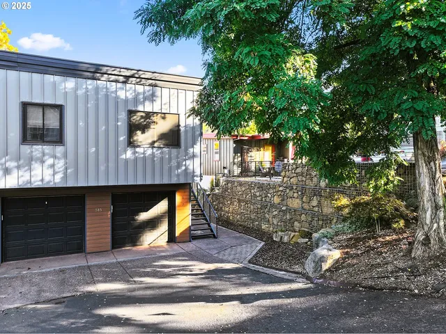 a view of a house with a tree front of house