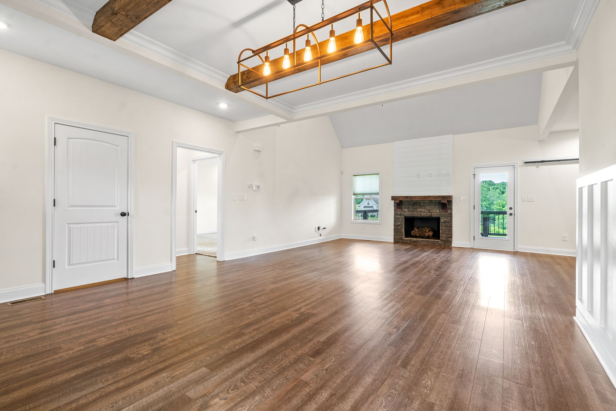 1452 Hickory Point Road Clarksville, TN 37043 - Photo 11 of 38 a view of empty room with wooden floor and fireplace