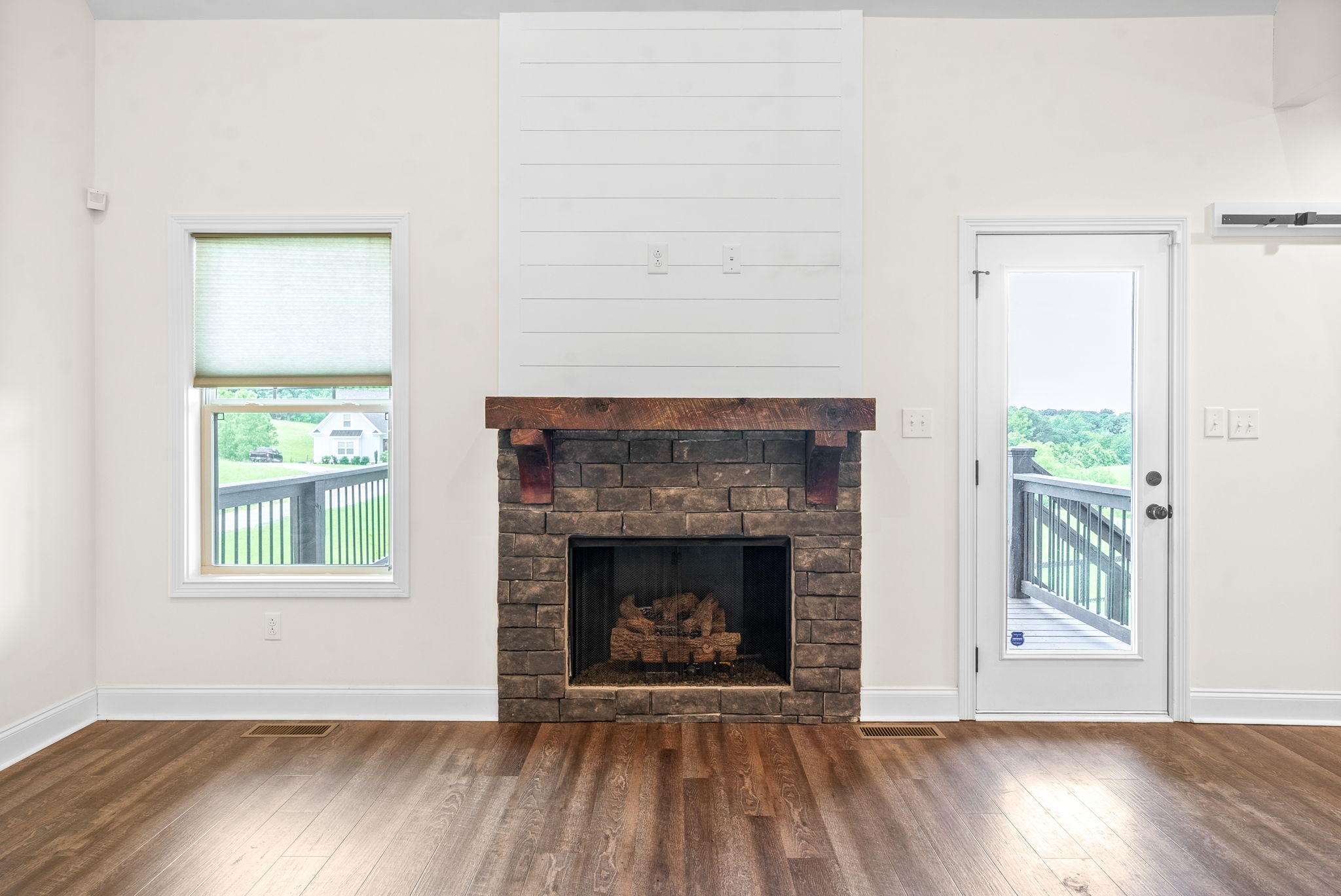 1452 Hickory Point Road Clarksville, TN 37043 - Photo 8 of 38 a view of an empty room with wooden floor fireplace and a window