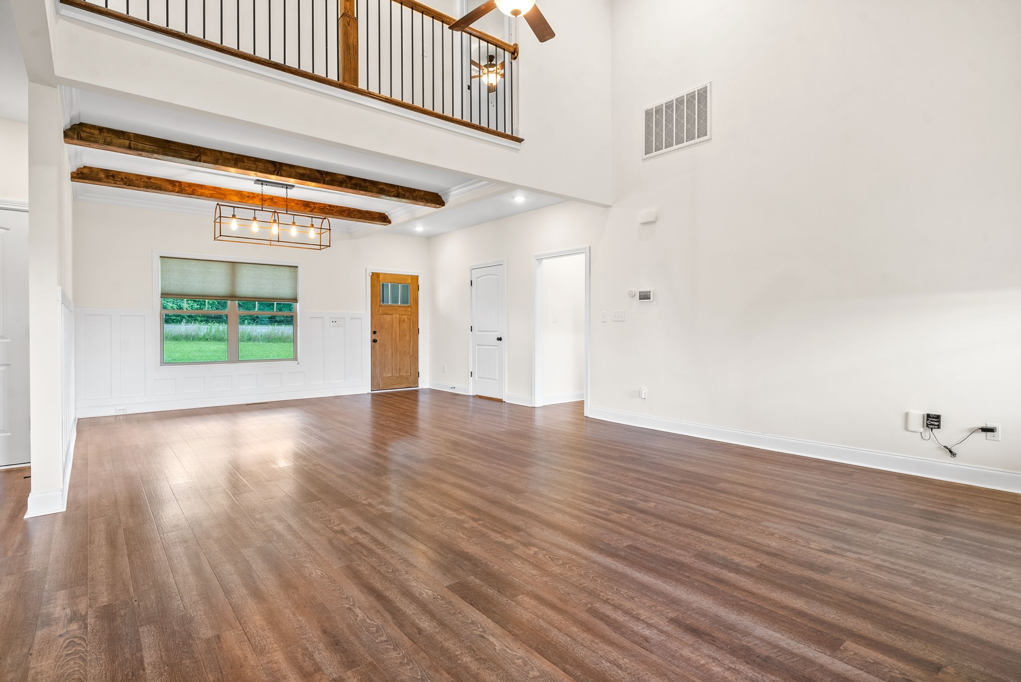 1452 Hickory Point Road Clarksville, TN 37043 - Photo 9 of 38 an empty room with wooden floor and windows