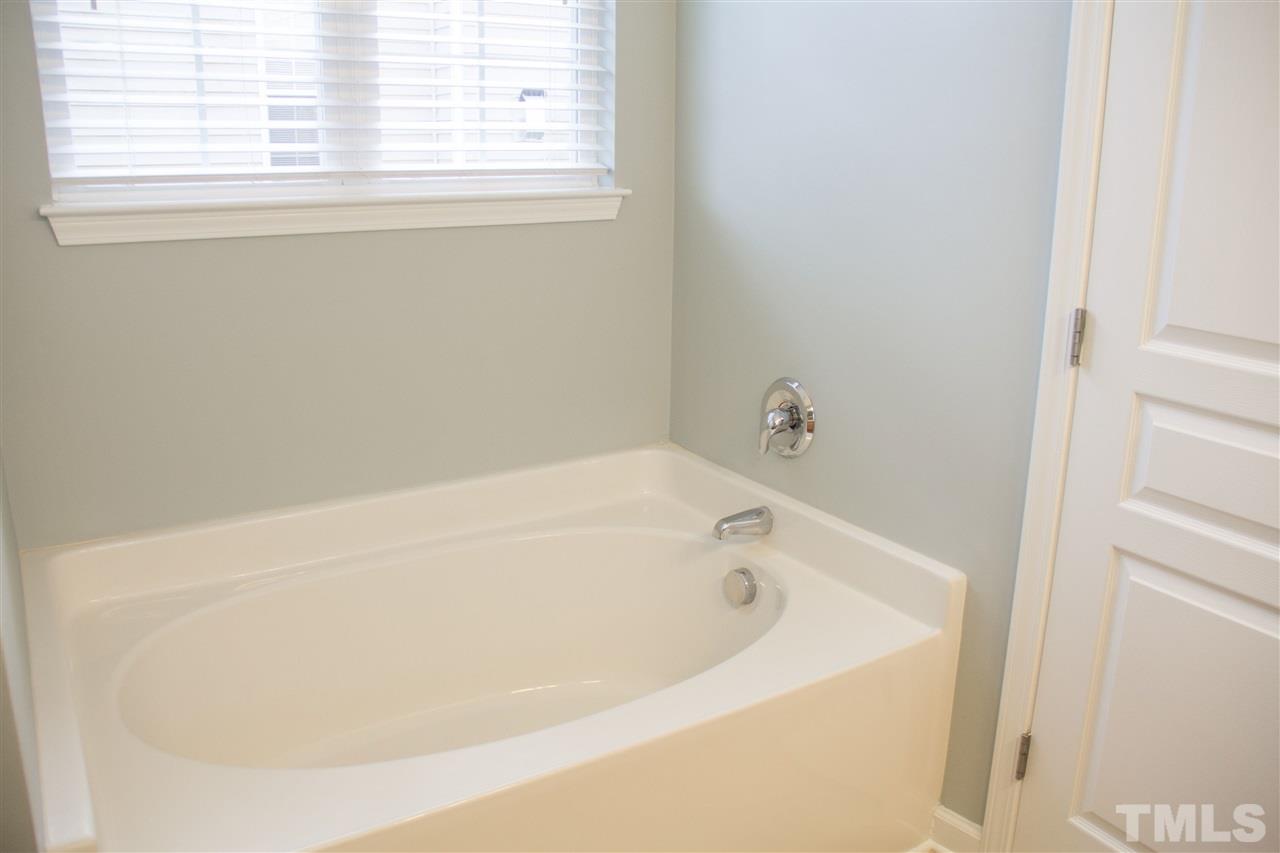 203 Hope Valley Road Knightdale, NC 27545 - Photo 14 of 25 a white bath tub sitting in a bathroom