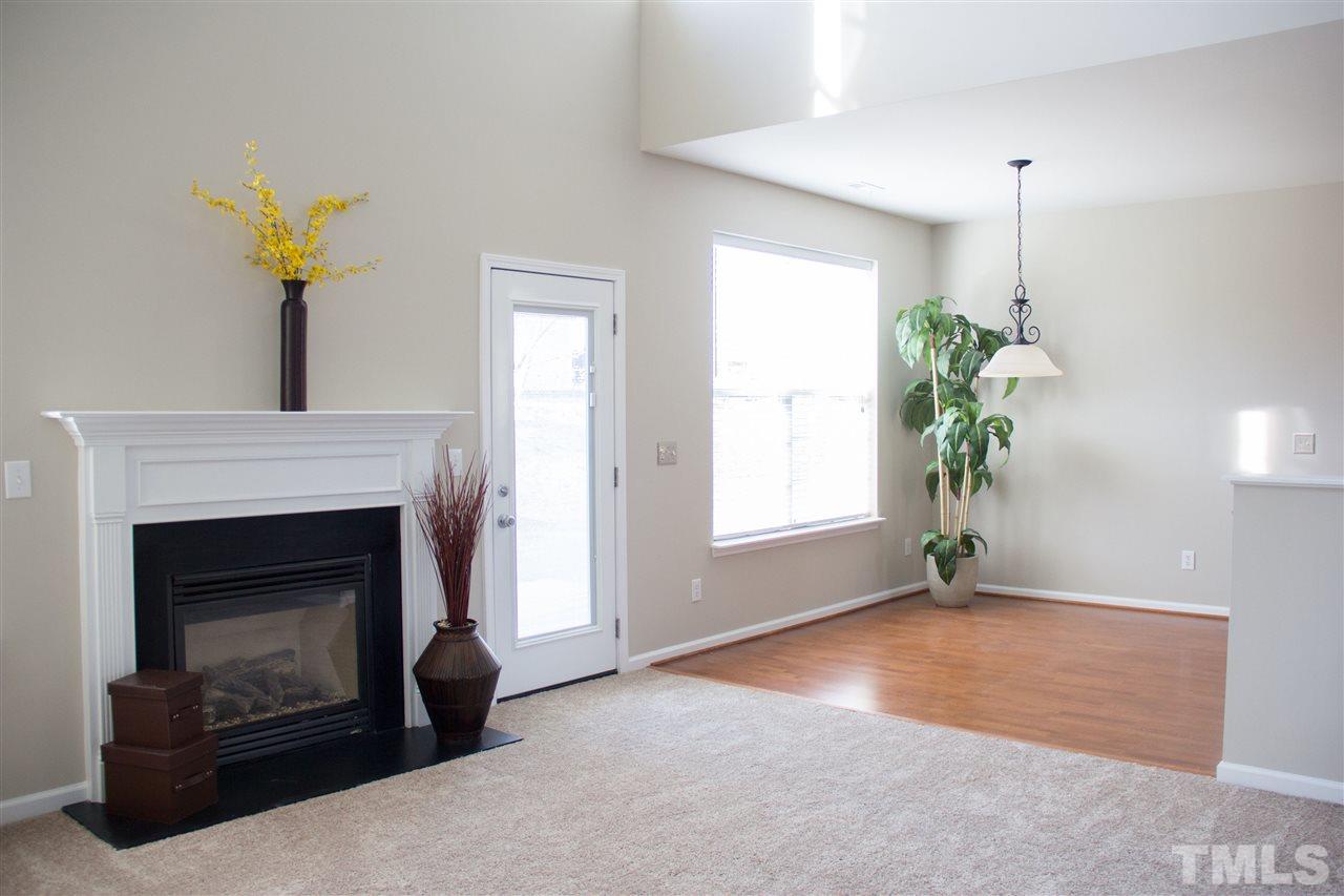 203 Hope Valley Road Knightdale, NC 27545 - Photo 4 of 25 a living room with a fireplace and a potted plant