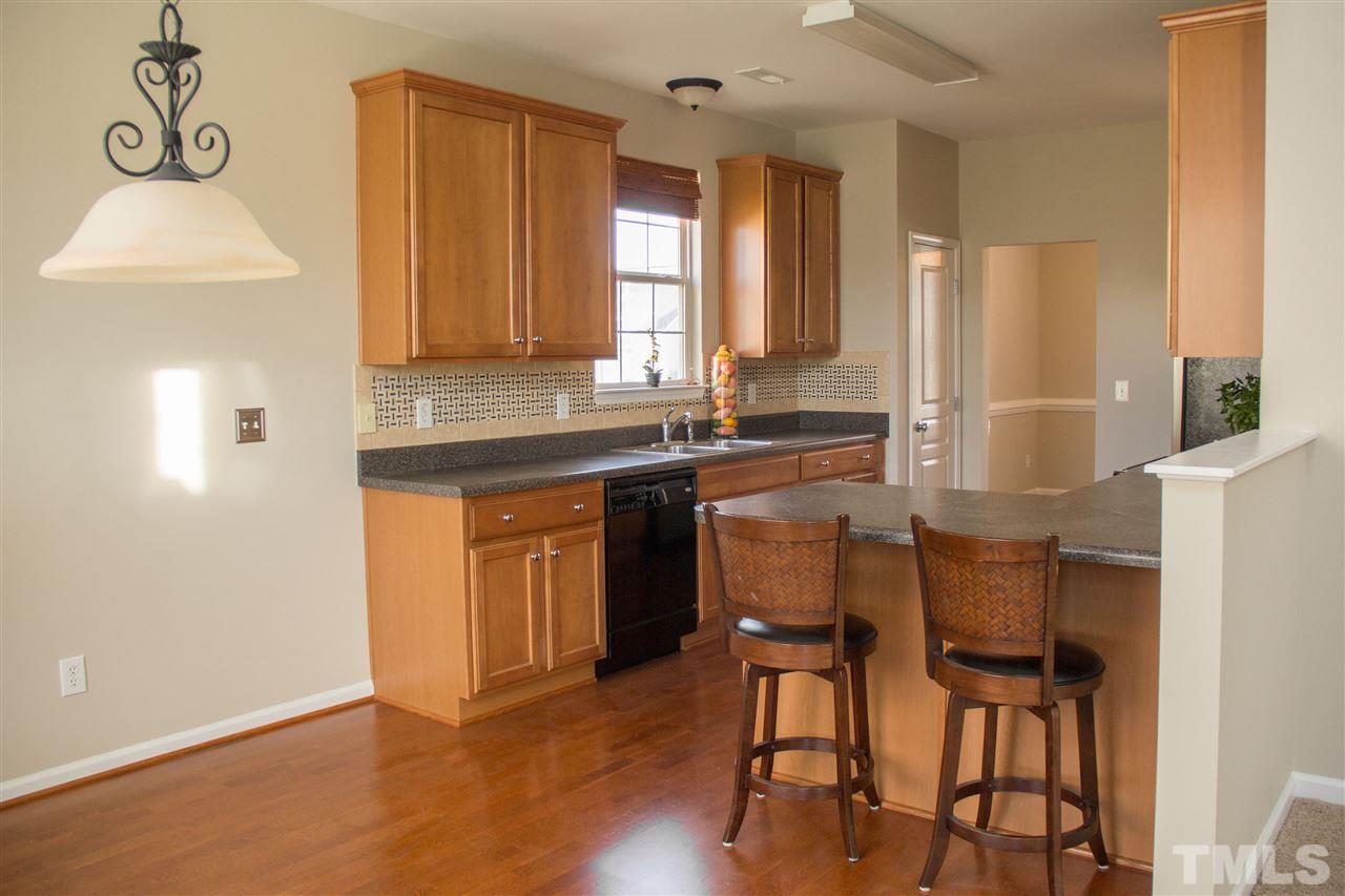203 Hope Valley Road Knightdale, NC 27545 - Photo 7 of 25 a kitchen with stainless steel appliances granite countertop a sink and a refrigerator