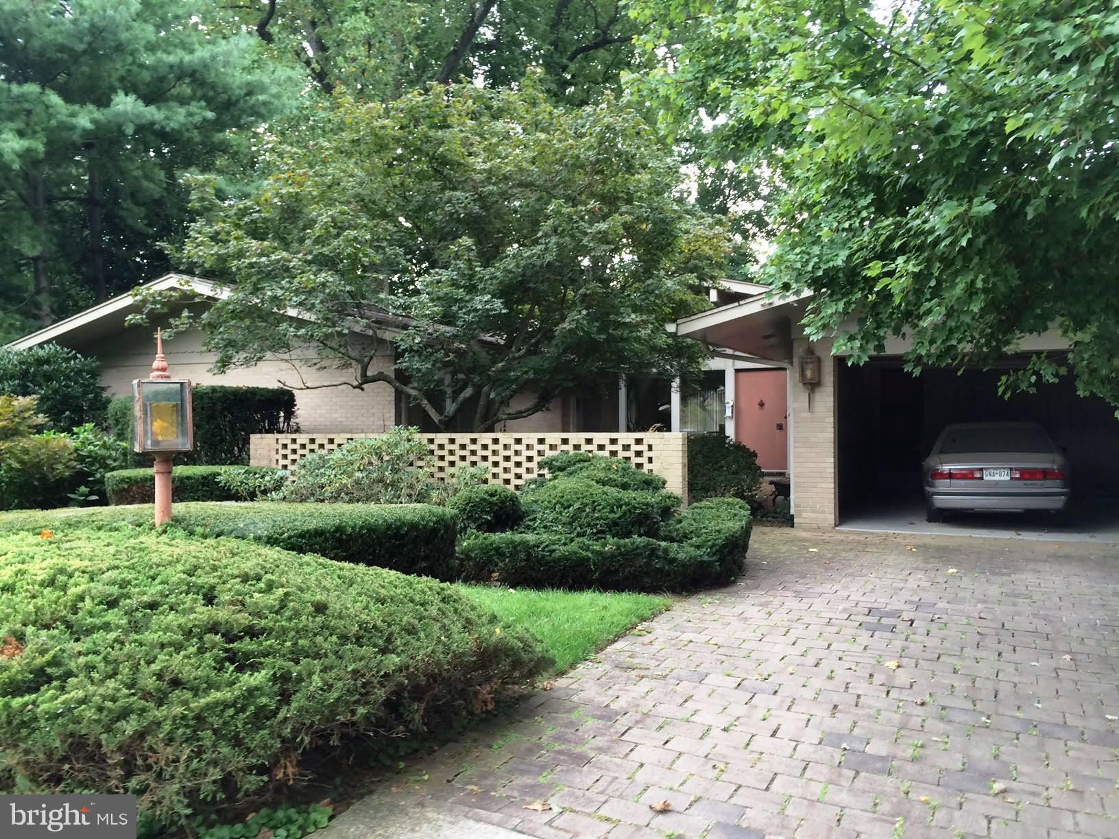 a front view of a house with a yard garage and outdoor seating