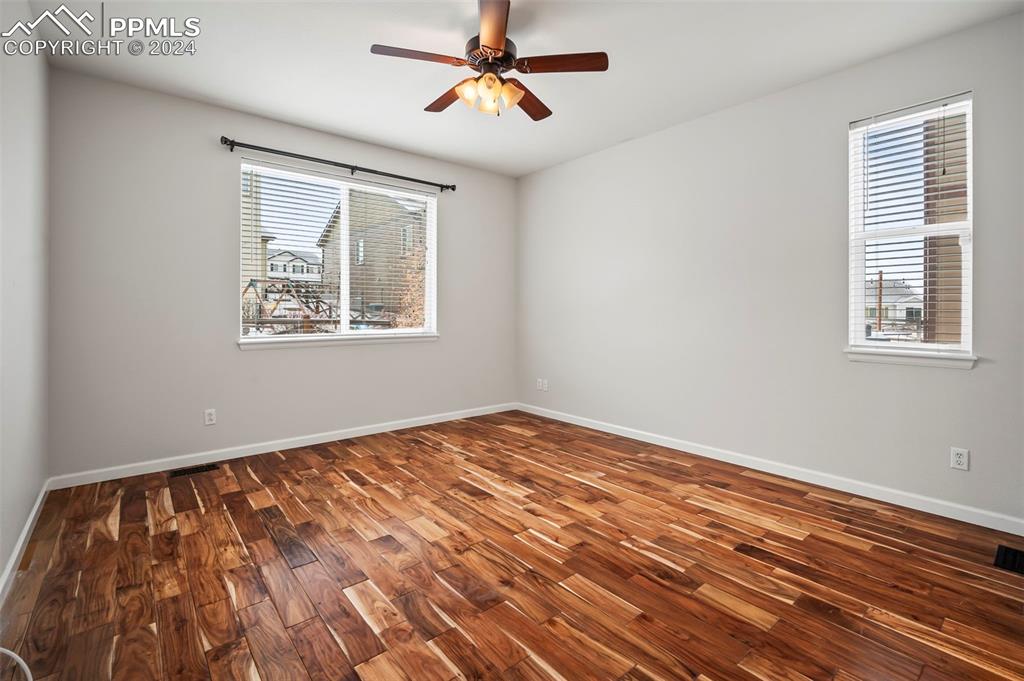 8238 Hollygrape Lane Colorado Springs, CO 80927 - Photo 11 of 35 a view of an empty room with window and a chandelier fan