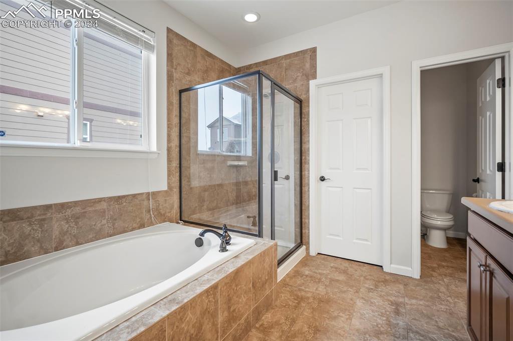 8238 Hollygrape Lane Colorado Springs, CO 80927 - Photo 14 of 35 a bathroom with a bathtub and a shower