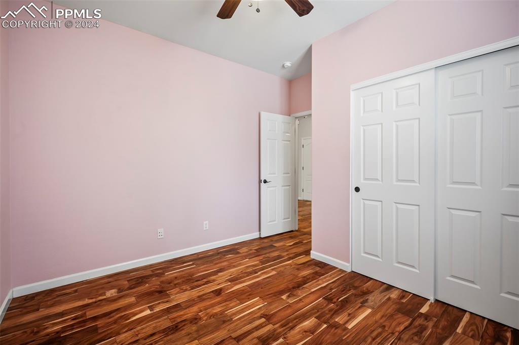 8238 Hollygrape Lane Colorado Springs, CO 80927 - Photo 15 of 35 a view of an empty room with wooden floor