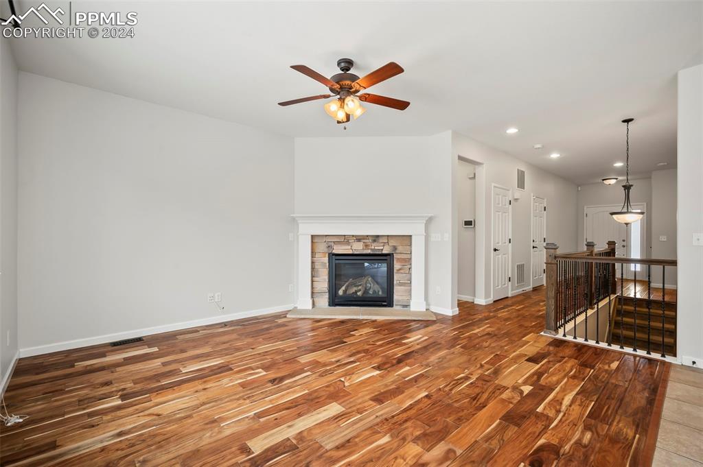 8238 Hollygrape Lane Colorado Springs, CO 80927 - Photo 2 of 35 a view of a livingroom with a fireplace and a chandelier fan