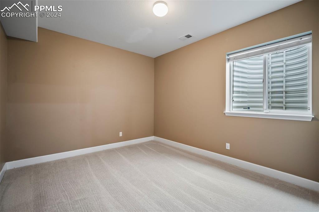 8238 Hollygrape Lane Colorado Springs, CO 80927 - Photo 22 of 35 a view of an empty room with a window