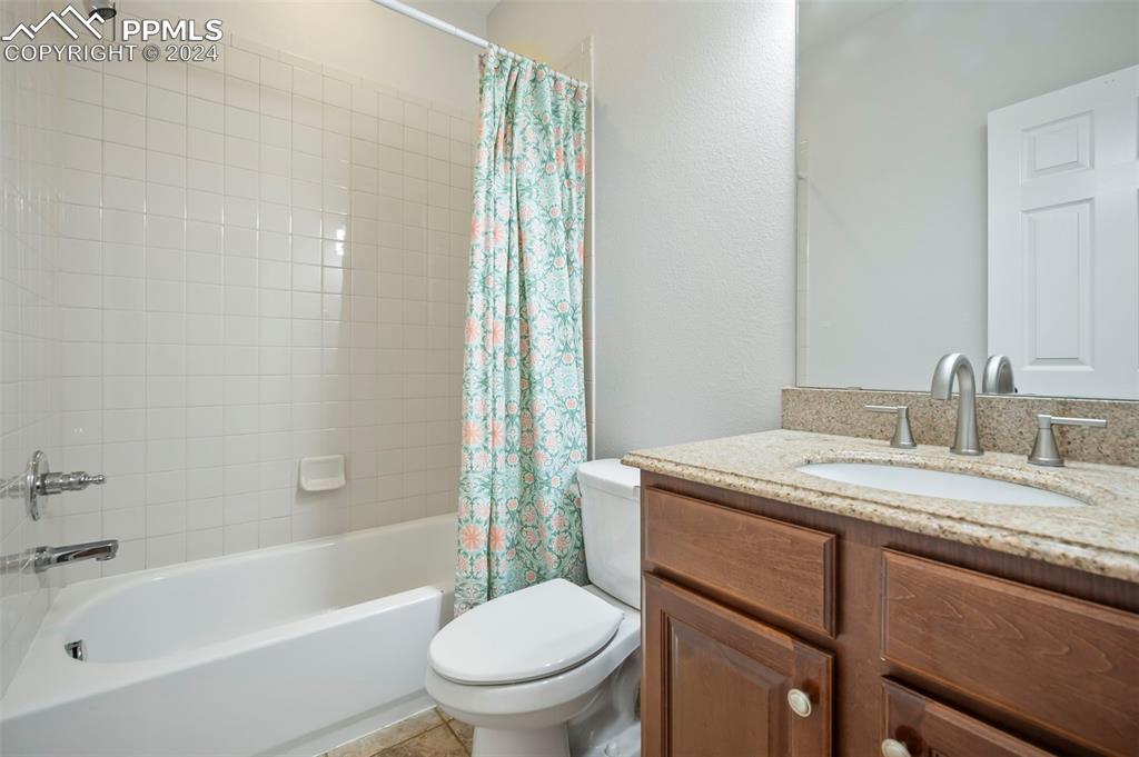 8238 Hollygrape Lane Colorado Springs, CO 80927 - Photo 26 of 35 a bathroom with a granite countertop sink toilet and shower
