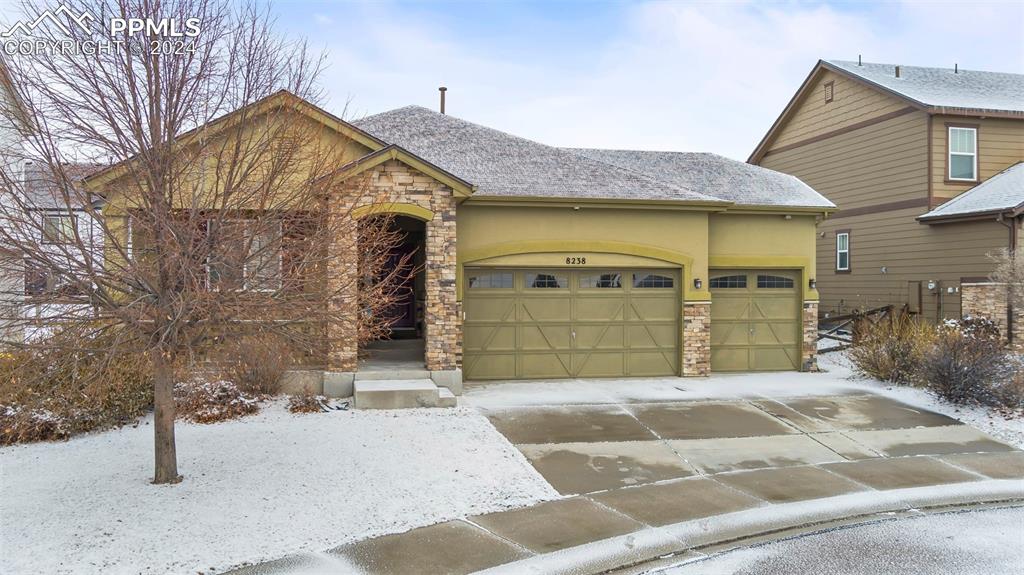 8238 Hollygrape Lane Colorado Springs, CO 80927 - Photo 35 of 35 a front view of a house with a yard and garage