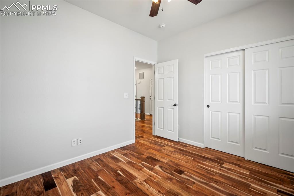 8238 Hollygrape Lane Colorado Springs, CO 80927 - Photo 9 of 35 a view of an empty room with wooden floor