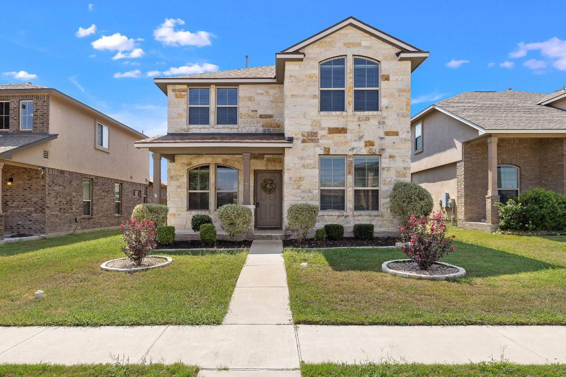 1432 Blake Street Leander, TX 78641 - Photo 1 of 26 a front view of a house with garden
