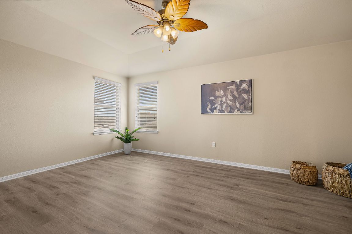 1432 Blake Street Leander, TX 78641 - Photo 14 of 26 a view of an empty room with window and wooden floor