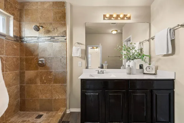 a bathroom with a sink double vanity and a shower