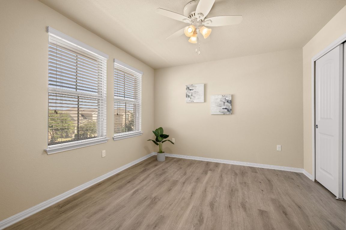 1432 Blake Street Leander, TX 78641 - Photo 19 of 26 a view of empty room with wooden floor and fan