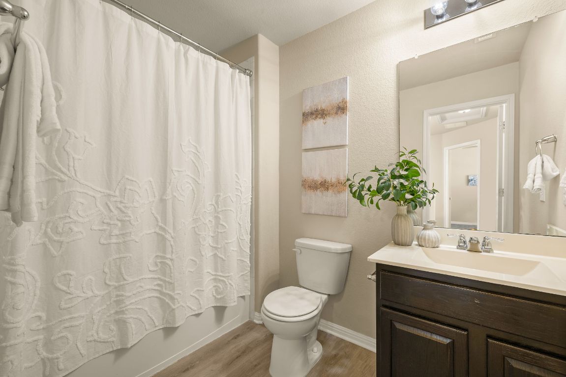 1432 Blake Street Leander, TX 78641 - Photo 21 of 26 a bathroom with a sink toilet and shower