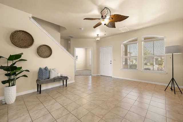 a view of entryway with livingroom and chandelier