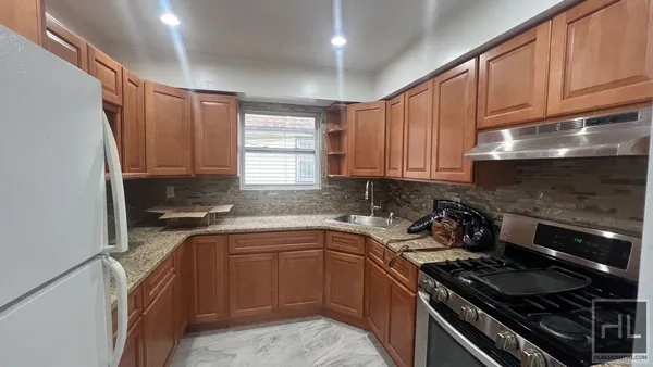 a kitchen with a sink stove top oven and cabinets