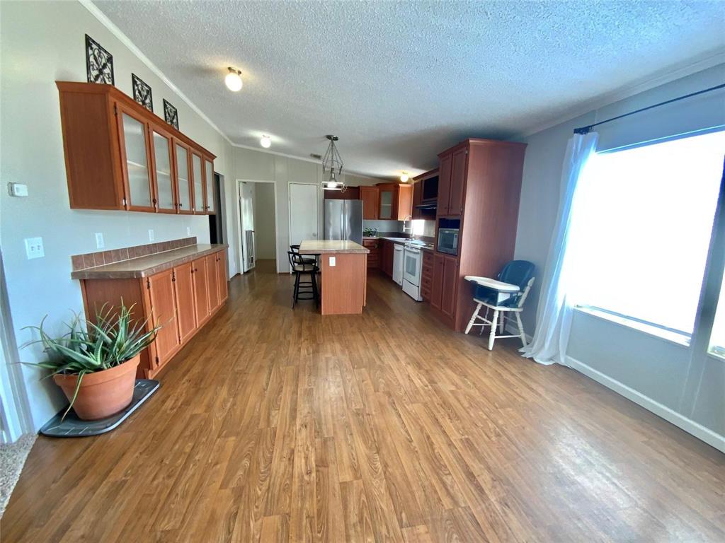 11255 Sam Reynolds Road Justin, TX 76247 - Photo 5 of 19 a living room with furniture and a wooden floor