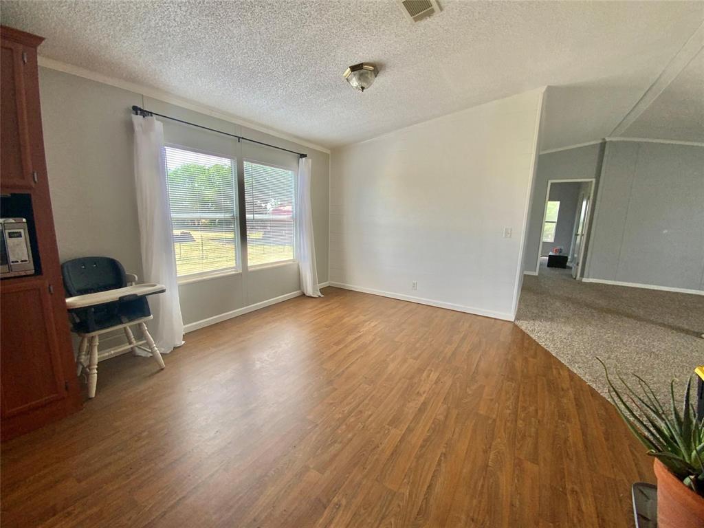 11255 Sam Reynolds Road Justin, TX 76247 - Photo 6 of 19 a view of room with window and wooden floor