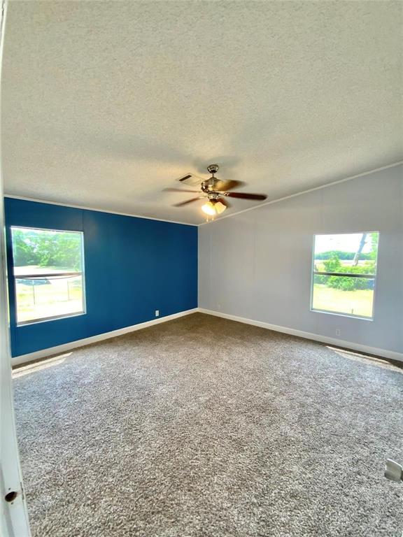 11255 Sam Reynolds Road Justin, TX 76247 - Photo 8 of 19 an empty room with windows & fan