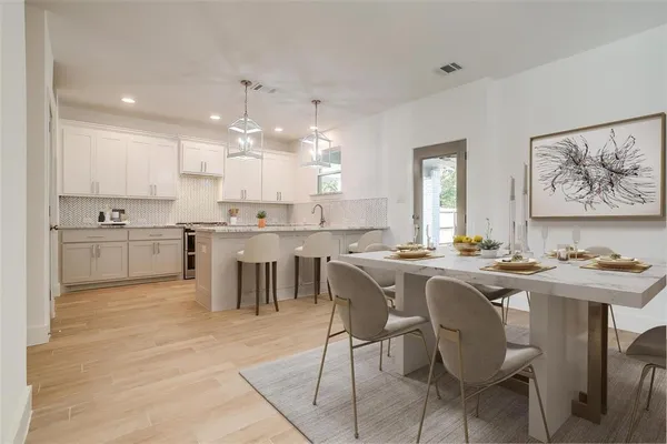 a kitchen with kitchen island granite countertop a sink and cabinets