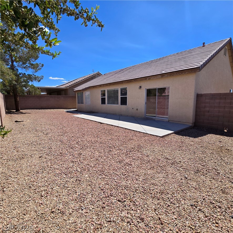 9234 Kingston Road Henderson, NV 89074 - Photo 32 of 38 A spacious, rock-covered backyard provides a low-maintenance outdoor living area with a wide patio.